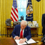 President Donald Trump signs an executive order as Treasury Secretary Scott Bessent, left, and Commerce Secretary Howard Lutnick watch in the Oval Office of the White House, Monday, Feb. 3, 2025,
