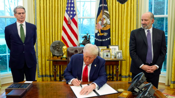 President Donald Trump signs an executive order as Treasury Secretary Scott Bessent, left, and Commerce Secretary Howard Lutnick watch in the Oval Office of the White House, Monday, Feb. 3, 2025,
